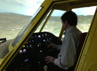 A customer flying the AT-802 simulator in X-Plane. This shows the juncture of the center and right-hand side projected images.
