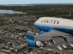 The stock 747 landing in Queens, NY. Shown with the UrbanMAXX Extreme scenery add-on. Image courtesy of AVSIM Online and Comanche.