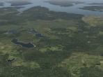 Forests, fields, and lakes meet in X-Plane 10